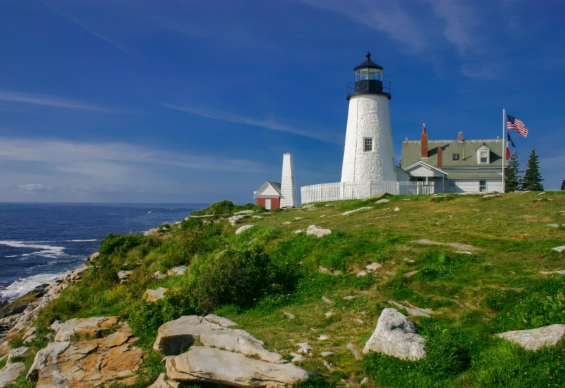 Museums and Lighthouses to Explore in Rockland Maine - white lighthouse on a hill overlooking ocean