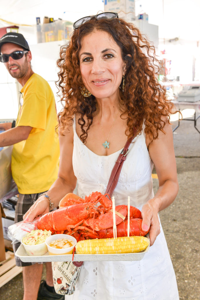 9 things you didn't know about the maine lobster festival - woman eating lobster